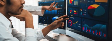 Analizci veri analizi ya da bilgisayar monitöründeki BI gösterge paneli üzerinde çalışıyor. Ticari pazarlama ve strateji planlaması için Fintech 'in şirket ofisindeki finansal verilerini analiz eden iş ekibi. Önde.