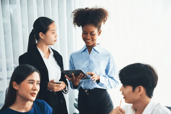 stock image Happy diverse business people work together, discussing in corporate office. Professional and diversity teamwork discuss business plan on desk with laptop. Modern multicultural office worker. Concord