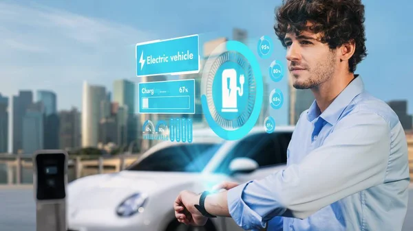 Businessman Checking Car Battery Status Hologram Smartwactch While Recharging Electricity — Stock Photo, Image