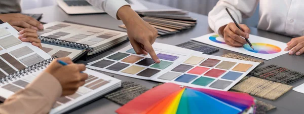 Group of professional interior designer and architect working together, planning and choosing color samples in office for house design or renovation. Insight