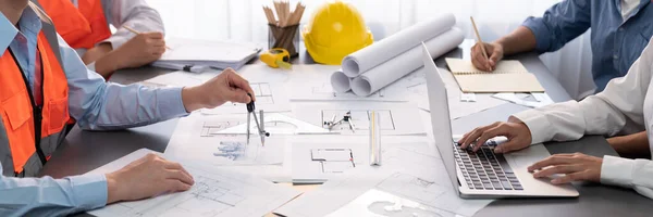 Architect or engineer working on building blueprint, contractor designing and drawing blueprint layout with tool for construction project. Civil engineer and architecture design concept. Insight