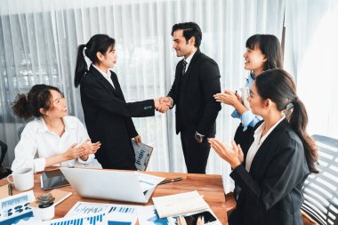 Bir grup iş adamı başarılı bir iş anlaşması toplantısı yaptıktan sonra el sıkıştı. Çeşitli yarış bürosu çalışanları şirket ofisinde pazarlama planlamasında ilerleme kaydettikten sonra kutlama yapıyorlar. Çok titiz.