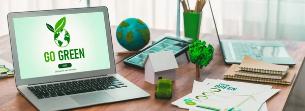 Green business company office with eco-friendly and environment conservation policy, office table with eco mockup and laptop screen display go green concept to save earth. Trailblazing