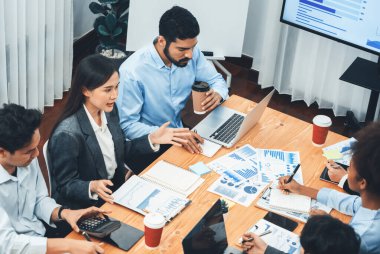 Üst düzey çok ırklı analiz ekibi toplantı masasındaki mali raporu analiz etmek için BI gösterge tablosu verilerini kullanıyor. Çeşitli iş adamlarından oluşan bir grup, iş kararı için FIntech 'in veri analizini kullanıyor. Uyum
