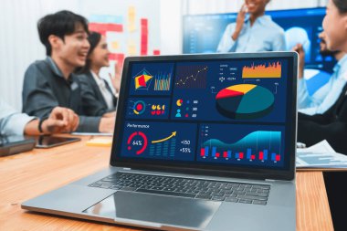 Takım toplantısı veya sunum sırasında iş büyüme stratejisi ve pazarlama göstergesi için veri analizi grafiği ve grafiğini gösteren dizüstü bilgisayardaki dijital finansal BI gösterge paneli. Uyum