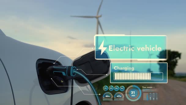 Ev充電ステーションからの電気自動車の充電エネルギーは 風力タービンファーム内のEv充電プラグケーブルによって未来的なスマートバッテリステータスホログラムを表示します 代替のクリーンエネルギー持続可能性 Peruse — ストック動画