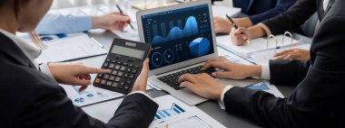 İş zekası ve veri analizi kavramı. Analizci ekibi laptop ekranında finansal veri analizi üzerinde çalışıyor. Etkili iş stratejik planlama için pazarlama göstergesi olarak. İçgörü