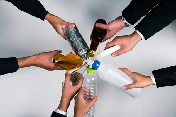 Top view hand holding garbage waste on isolated background. Eco-business recycle waste policy in corporate responsibility. Reuse, reduce and recycle for sustainability environment. Quaint
