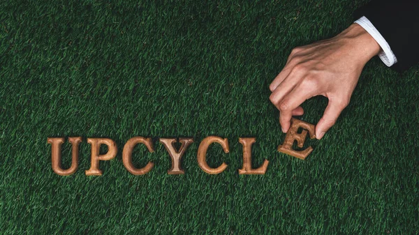 Environmental awareness campaign showcase arranged by hand recycle message in on biophilic green grass background. Environmental social governance concept idea for sustainable and greener future. Gyre