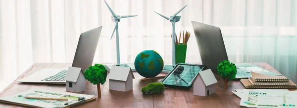Environment friendly company office table with various eco mockup for environmental conservative concept. Green business with zero net reducing impact on global warming. Trailblazing