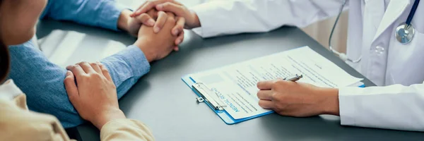 Doctor Providing Compassionate Healthcare Consultation While Young Couple Patient Holding — Stock Photo, Image