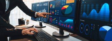 Analizci veri analizi ya da bilgisayar monitöründeki BI gösterge paneli üzerinde çalışıyor. Ticari pazarlama ve strateji planlaması için Fintech 'in şirket ofisindeki finansal verilerini analiz eden iş ekibi. Önde.