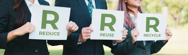 Group of business people stand united, holding eco-friendly idea and concept for environmental awareness campaign embracing waste recycling concept for greener environment with recycle lifestyle.Gyre
