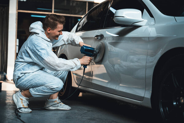 Automotive repair shop, concept of car detailing and polishing by professional car service worker with precision using orbital polisher machine creative captivating automotive flourish . Oxus