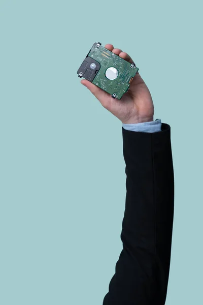 Businessmans hand holding electronic waste on isolated background. Eco-business recycle waste policy in corporate responsibility. Reuse, reduce and recycle for sustainability environment. Quaint