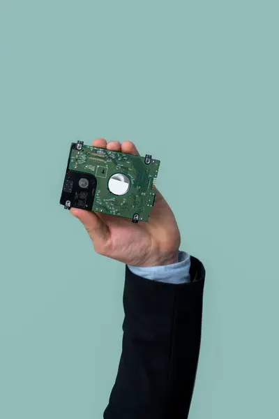Businessmans hand holding electronic waste on isolated background. Eco-business recycle waste policy in corporate responsibility. Reuse, reduce and recycle for sustainability environment. Quaint