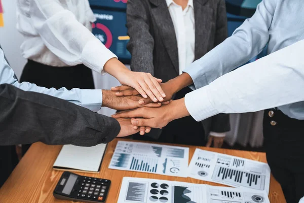 Multiracial office workers hand stack shows solidarity, teamwork and trust in diverse community. Businesspeople unite for business success through synergy and collaboration by hand stacking. Concord