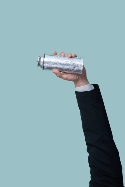 Businessmans hand holding spray can on isolated background. Eco-business recycle waste policy in corporate responsibility. Reuse, reduce and recycle for sustainability environment. Quaint
