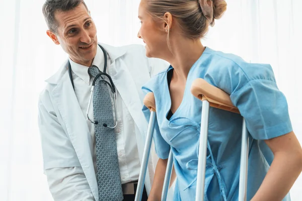 Doctor Takes Care Patient Crutch Hospital Physical Therapist Leg Injury — Stock Photo, Image