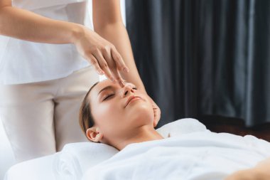 Kafkasyalı kadın stres önleyici kafa masajından ve lüks tatil beldesi ya da otel spa salonundaki modern ışık ortamında yüz güzelliği eğlencelerini şımartmaktan hoşlanıyor. Sessiz.