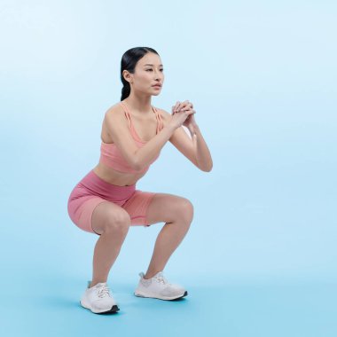 Egzersiz yapan enerjik bir kadın. Genç atletik Asyalı kadın gücü ve dayanıklılık antrenmanı rutin antrenman olarak. Tüm vücut stüdyosu izole edilmiş arka planda çekilmiş..