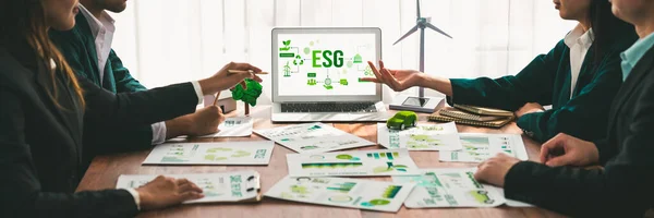 ESG environmental social governance display on laptop on eco-friendly company meeting with business people implementing environmental protection for clean and sustainable future ecology. Trailblazing