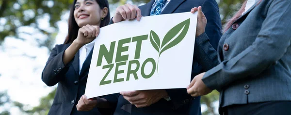 Group of business people stand united, holding eco-friendly idea and concept for environmental awareness campaign by business corporate to embrace net zero emission and environmental friendly. Gyre