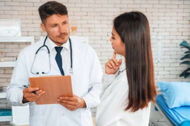 Profesyonel üniformalı doktor hastanedeki ya da klinikteki hastayı muayene ediyor. Sağlık, tıbbi ve doktor servis konsepti. Jivy