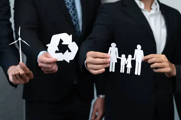 Business people holding eco-friendly and recycle icons as corporate responsibility for social and environment concept with waste management for greener community. Quaint