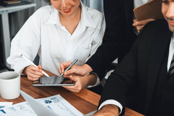 Diverse group of business analyst team analyzing financial data report paper on office table. Chart and graph dashboard by business intelligence analysis for strategic marketing planning Meticulous