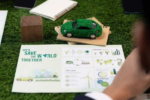 Group of business people planning strategic marketing in electric car company meeting for eco-friendly EV car using sustainable and alternative power contribute to greener future. Quaint