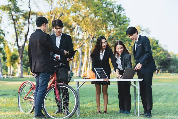 Group of asian business people with strong teamwork establish outdoor eco business office at natural park develop environmentally friendly and sustainable technology project for greener future. Gyre