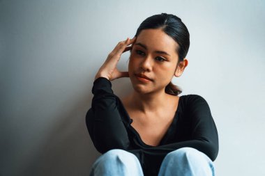 Depressed young Asian woman with mental health problem in mind need uttermost treatment from overthinking fatigue, disruptive thought, dissocial, anxiety and other mental health disorders . clipart