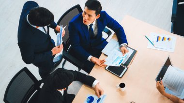 Business people group meeting shot from top view in office . Profession businesswomen, businessmen and office workers working in team conference with project planning document on meeting table . Jivy clipart