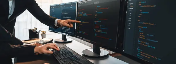 stock image Software development team working together in office, coding script display on computer monitor. Programmer and software engineer working in tech developer company. Trailblazing