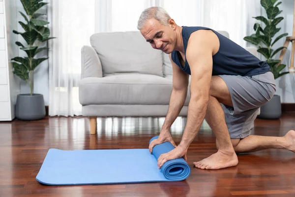 Active Sporty Senior Man Preparing Rolling Fitness Exercising Mat Living Royalty Free Stock Photos