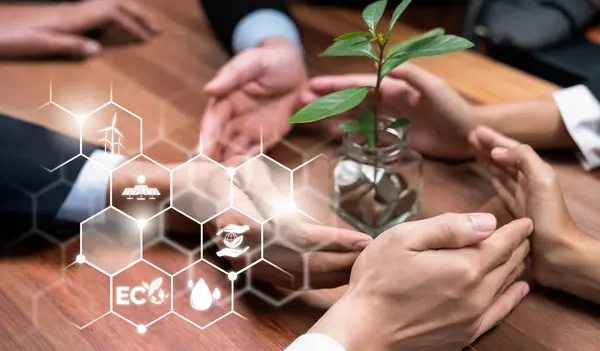 ESG business partner join hand around plant grown in money saving jar with digital eco technology icon symbolize collective investment in environmental protection for sustainable ecosystem. Reliance