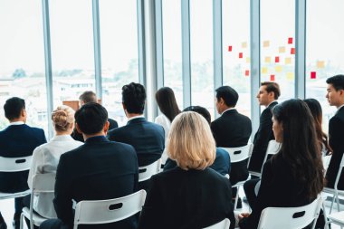 Group of business people meeting in a seminar conference . Audience listening to instructor in employee education training session . Office worker community summit forum with expert speaker . Jivy clipart