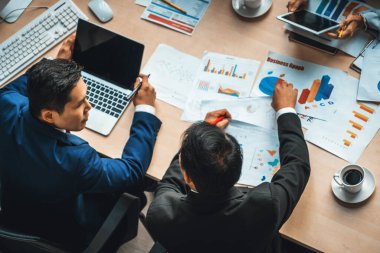 İş adamları grup toplantısı ofiste yukarıdan çekildi. İş kadınları, iş adamları ve ofis çalışanları toplantı masasında proje planlama belgeleriyle takım konferansında çalışıyorlar. Jivy