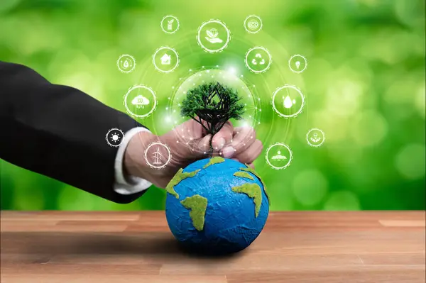 Businessman holding Earth with eco friendly icon design symbolize business company commitment to protect planet Earths ecosystem with net zero technology and ESG practice. Reliance