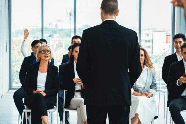 Group of business people meeting in a seminar conference . Audience listening to instructor in employee education training session . Office worker community summit forum with expert speaker . Jivy