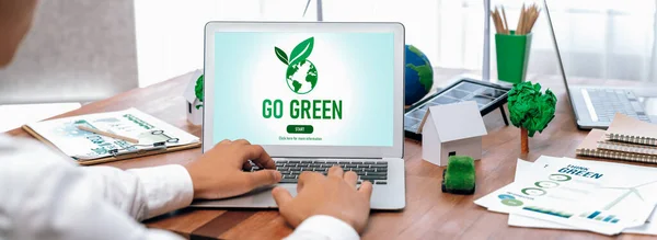 Go green for environmental awareness concept display on laptop on eco-friendly company meeting with businessman initiate environmental protection for clean and sustainable future ecology. Trailblazing