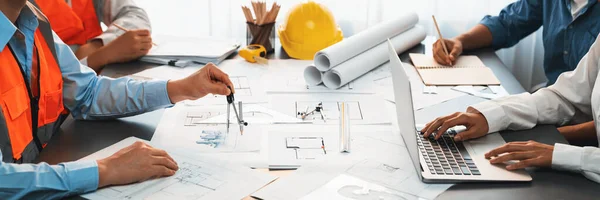 Architect or engineer working on building blueprint, contractor designing and drawing blueprint layout with tool for construction project. Civil engineer and architecture design concept. Insight