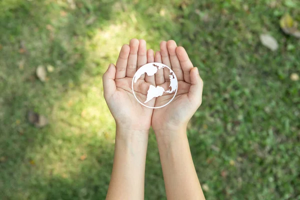 stock image Top view hand holding Earth planet icon symbolize eco-friendly commitment to environmental protection and zero carbon emission. Earth World Day concept to promote eco awareness. Gyre