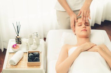 Kafkasyalı kadın stres önleyici kafa masajından ve lüks tatil beldesi ya da otel spa salonundaki modern ışık ortamında yüz güzelliği eğlencelerini şımartmaktan hoşlanıyor. Sessiz.