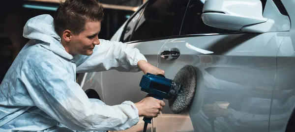 Automotive repair shop, concept of car detailing and polishing by professional car service worker with precision using orbital polisher machine creative captivating automotive flourish . Panorama Oxus