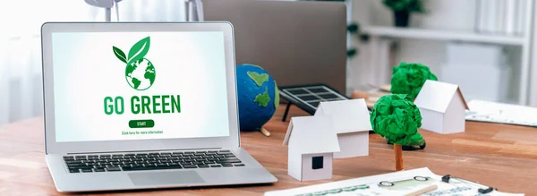 Green business company office with eco-friendly and environment conservation policy, office table with eco mockup and laptop screen display go green concept to save earth. Trailblazing