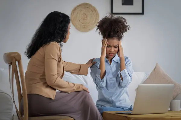 Sad PTSD woman patient in crucial therapy for mental health with psychologist, depression or grief after life failure. Frustrated trauma young woman talking to a psychologist about emotion in clinic