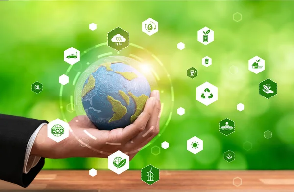 Businessman holding Earth with eco friendly icon design symbolize business company commitment to protect planet Earths ecosystem with net zero technology and ESG practice. Reliance
