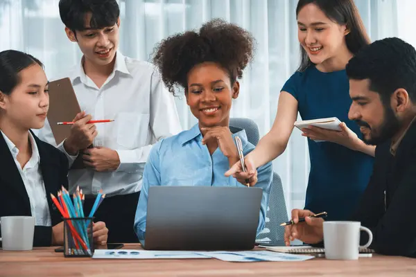 stock image Happy diverse business people work together, discussing in corporate office. Professional and diversity teamwork discuss business plan on desk with laptop. Modern multicultural office worker. Concord